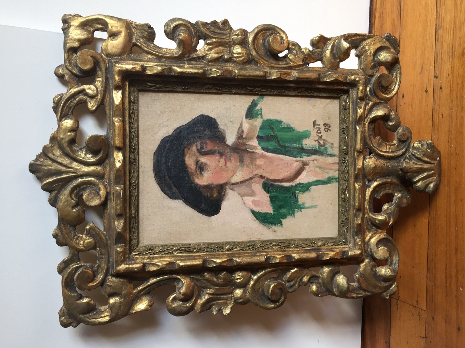 Antique oil portrait of a woman in a carved giltwood frame