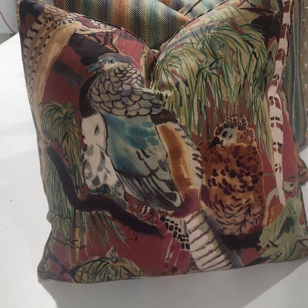 A velvet tapestry scatter cushion in a bird-and-palm design