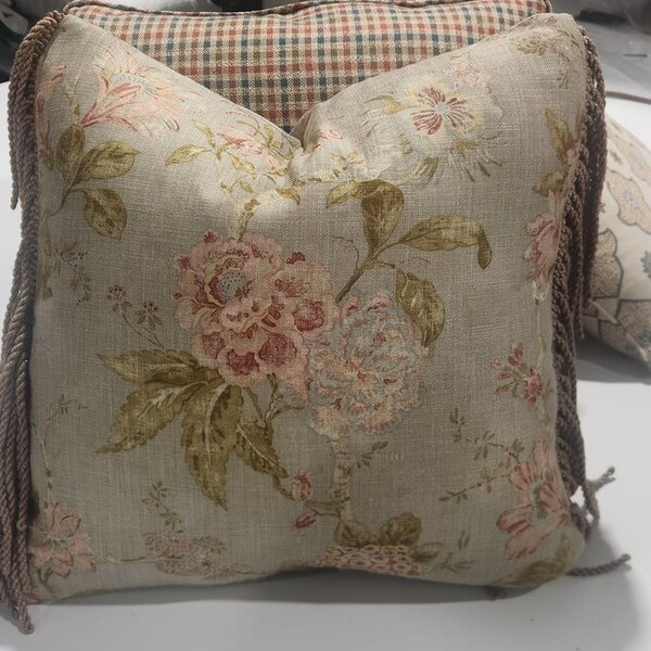 A floral linen scatter cushion finished with bullion rope fringe