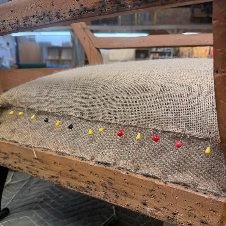A hessian foundation stretched over the frame and pinned
