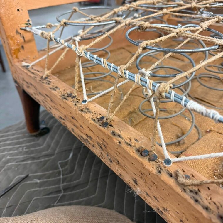 Hand-tied coil springs laced to the frame with twine