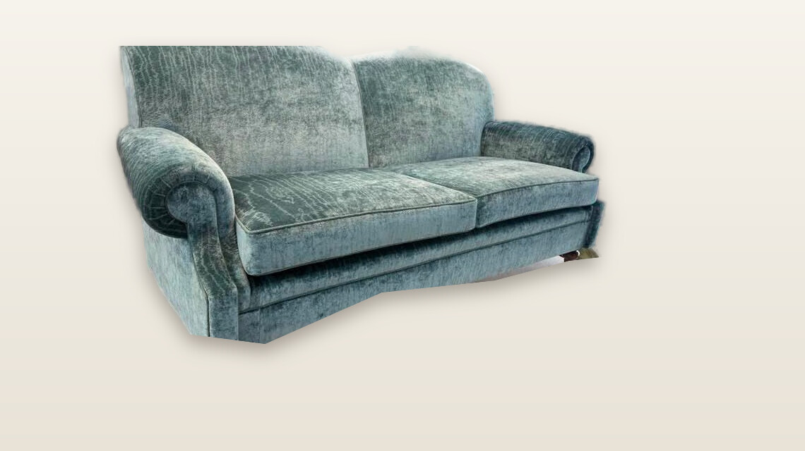 A two-seater sofa reupholstered in sage-green velvet in the Show Pony workshop